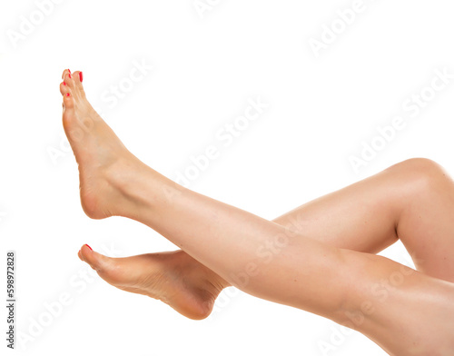 Female bare legs lifted up, smooth skin care. Isolated on white.