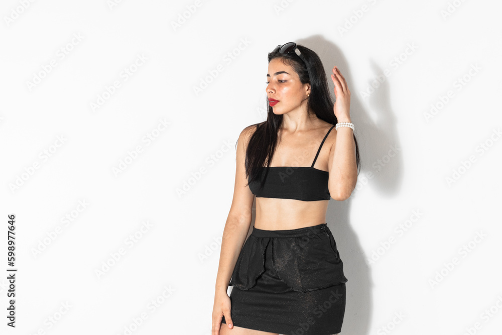 portrait of beautiful brown-skinned latina woman posing and looking sideways, on a white background portrait of beautiful brown-skinned latina woman posing and looking sideways, on a white background