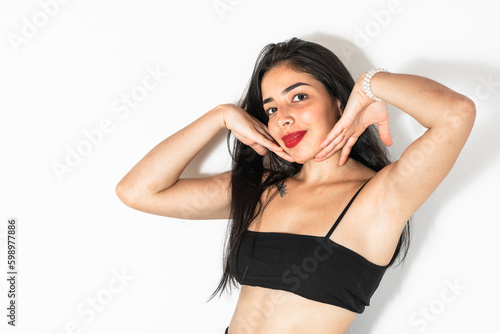 close-up portrait of a beautiful Latin teenage girl  placing her hands on her cheeks.