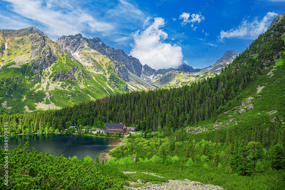 Picturesque panoramic view of Popradske Pleso, Tatra mountains, Slovakia. Lake Popradske pleso with mountain hotel in High Tatras.
