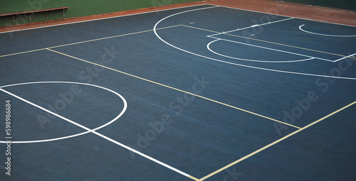 Keep calm and come shoot some hoops. an empty basketball court.