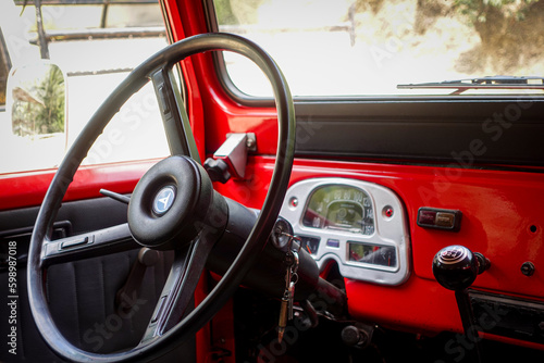  Red Classic Toyota. A classic JF40 off road 4x4 vehicle with hardtop from the 1978. Old toyota interior. © Agustin