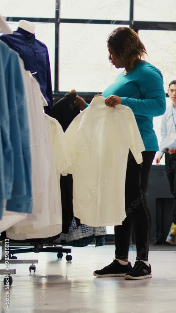 African american customer analyzing shirt fabric in modern boutique, shopping for trendy merchandise. Stylish woman wanting to buy trendy clothes for new wardrobe in clothing store. Generative AI African american customer analyzing shirt fabric in modern boutique, shopping for trendy merchandise. Stylish woman wanting to buy trendy clothes for new wardrobe in clothing store. Generative AI