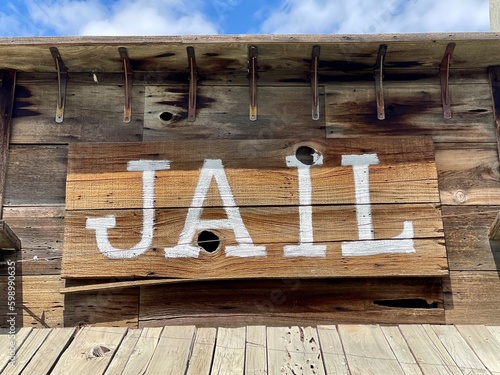 Old wooden jail sign in a western themed town