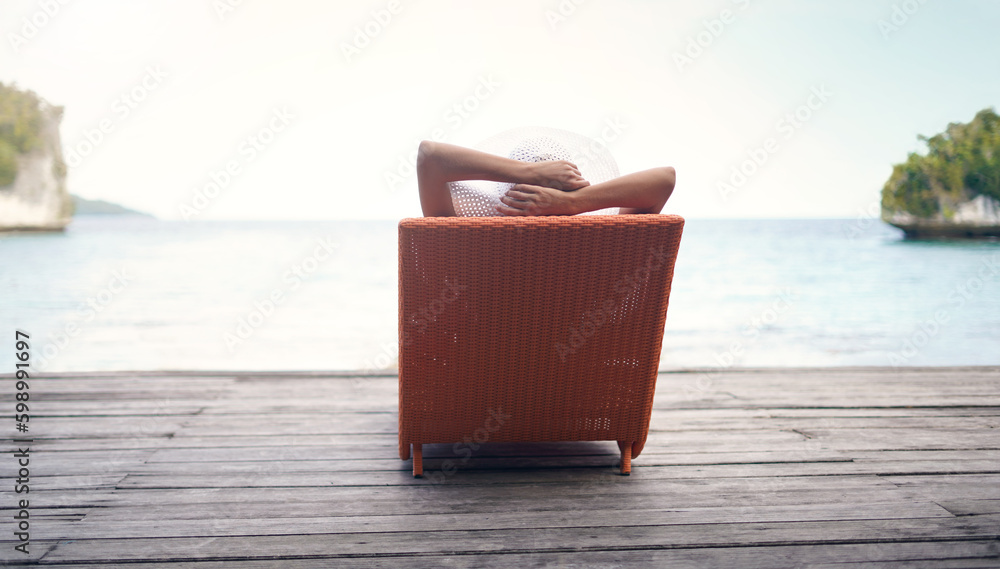 Found my perfect relaxation spot. Rearview shot of an unrecognizable woman sitting on a sun lounger alone during a vacation in Indonesia. Found my perfect relaxation spot. Rearview shot of an unrecognizable woman sitting on a sun lounger alone during a vacation in Indonesia.