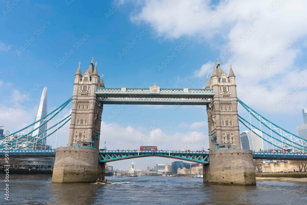 Obraz premium Tower Bridge in London with a bus and boat in view