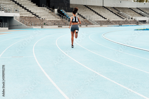 Leaving the people who said I couldnt behind me. Rearview shot of an unrecognizable athlete running along a track field alone during an outdoor training session.