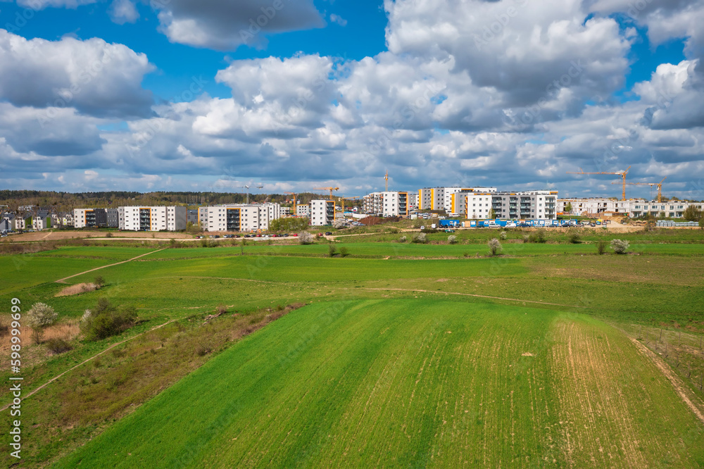 Building constructions by the green spring fields in Gdansk, Poland