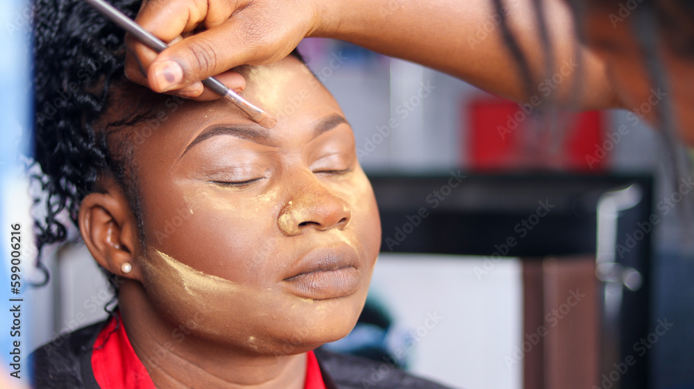 Applying makeup on eyebrow of a woman. Makeup treatment on face Applying makeup on eyebrow of a woman. Makeup treatment on face