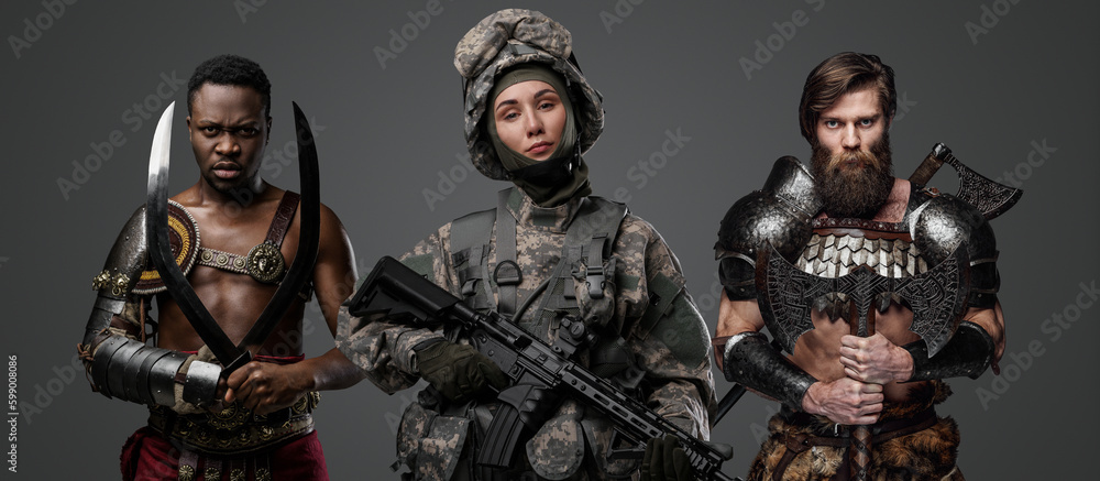 Shot of military woman with rifle and greek gladiator with scandinavian barbarian. Shot of military woman with rifle and greek gladiator with scandinavian barbarian.