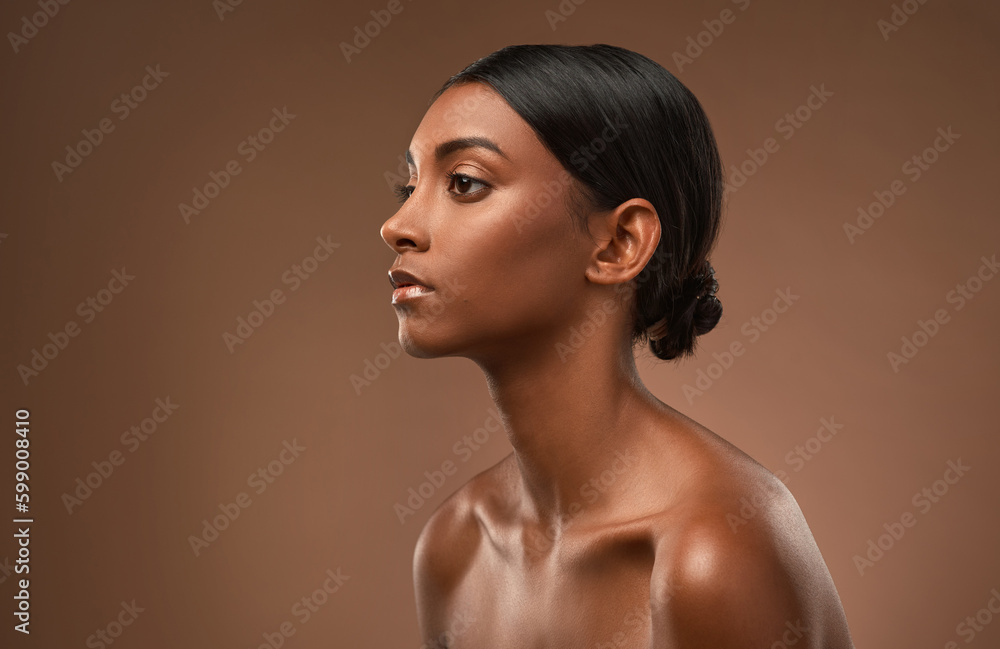 No sticks no shanks and no stones, no broken bones. Side shot of a beautiful young woman posing against a brown background. No sticks no shanks and no stones, no broken bones. Side shot of a beautiful young woman posing against a brown background.