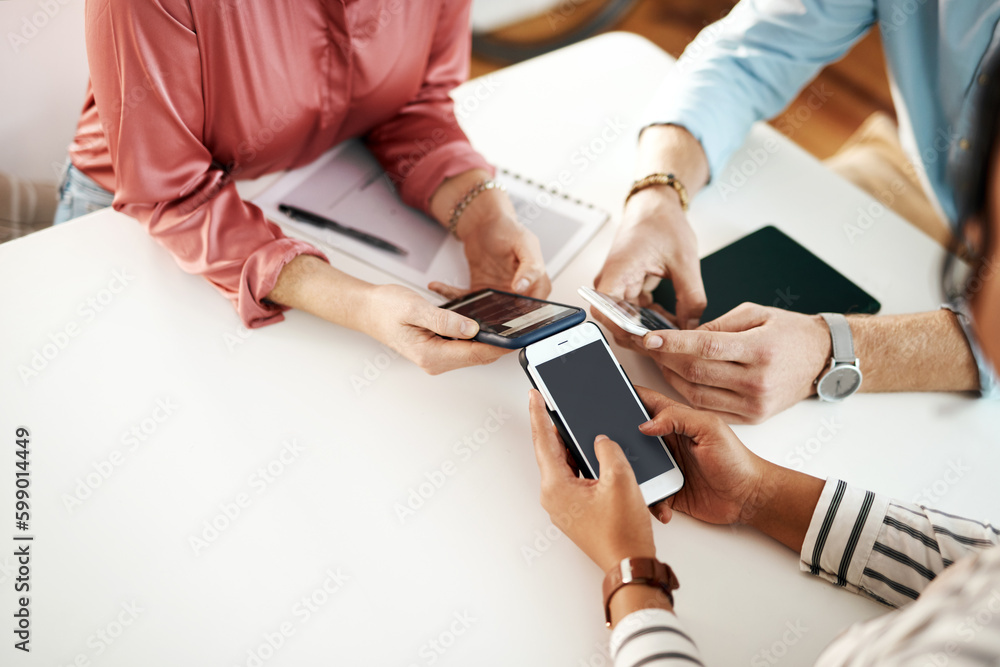 Fototapeta premium We achieve great things with technology and our minds. an unrecognizable group of businesspeople sitting together and using their cellphones during a meeting.