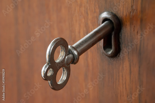 Ancient key. Old key in the keyhole. Shallow depth of field. Selective focus