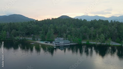4K Aerial Drone video of Morning Sunrise over Lake Placid with Mountains during Summer. Clouds visible