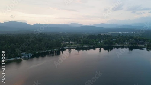 4K Aerial Drone Arc Orbit of Sunrise over Lake Placid with Mountains. Reflections in lake