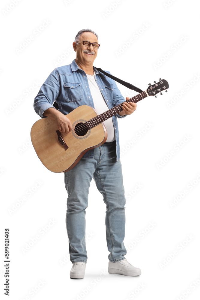 Full length portrait of a mature man standing and playing an acoustic guitar Full length portrait of a mature man standing and playing an acoustic guitar