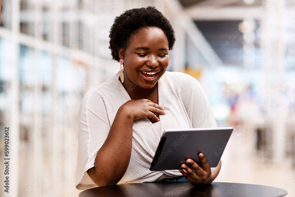 Staying productive around the office. a young businesswoman using a digital tablet in an office. Staying productive around the office. a young businesswoman using a digital tablet in an office.