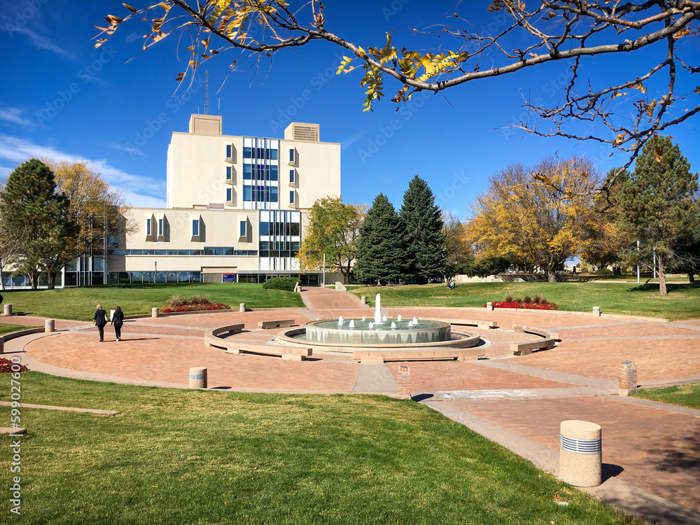 Library building and campus with students at aspiring Colorado State University against blue sky