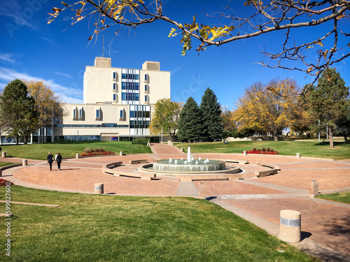 Library building and campus with students at aspiring Colorado State University against blue sky photo