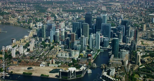 Canary Wharf aerial view with its moderns skyscrapers. This is one of the financial centers of London. Millwall Inner Dock. Train passing by South Quay station. Modern high rise buildings. England. UK photo