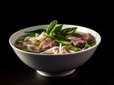 bowl of pho soup with thinly sliced beef, bean sprouts, and basil leaves