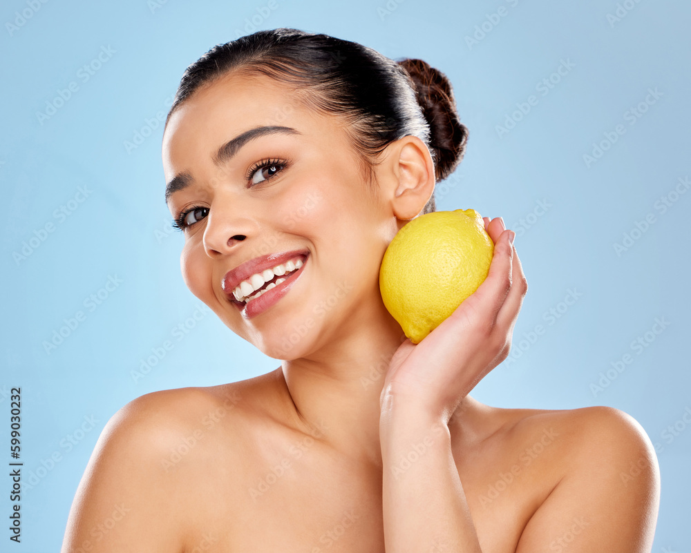 Beauty is my business. Studio portrait of an attractive young woman posing with a lemon against a blue background. Beauty is my business. Studio portrait of an attractive young woman posing with a lemon against a blue background.