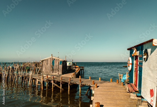 Wooden walkways and huts of the Cais de Palafitas da Carrasqueira.,Palafitico da Carrasqueira Pier in  Comporta Portugal
Europe Travel Portugal Alentejo beautiful Destinations