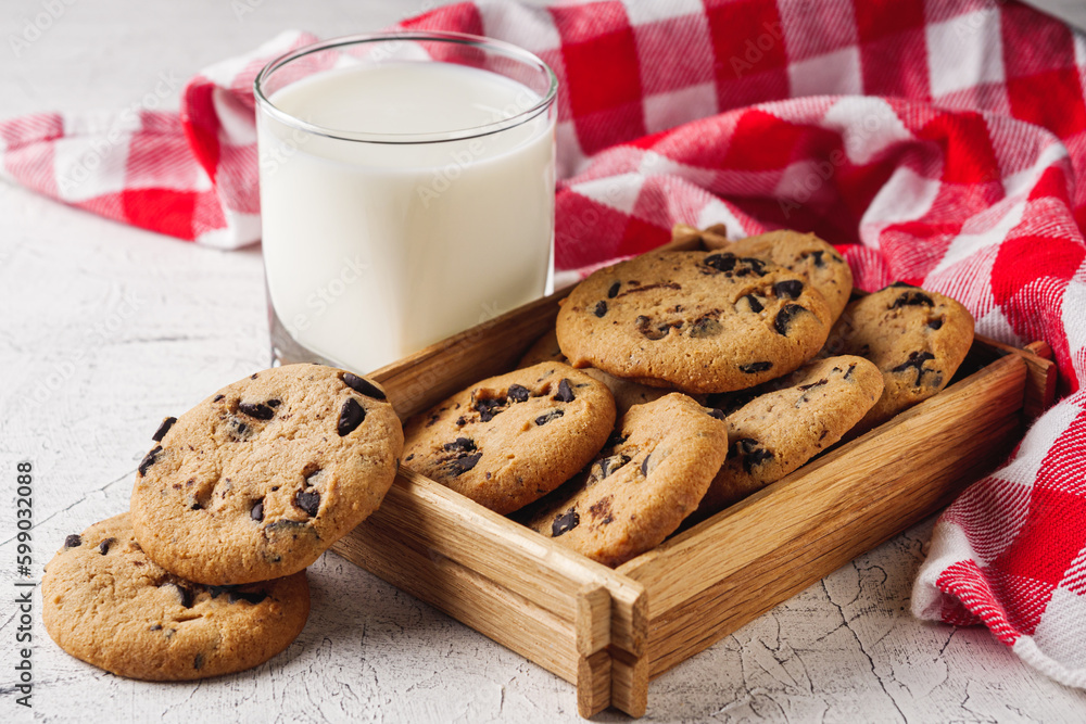 fresh healthy milk and cookies on white wood background