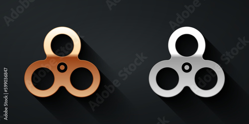 Gold and silver Fidget spinner icon isolated on black background. Stress relieving toy. Trendy hand spinner. Long shadow style. Vector