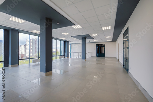 empty modern hall room with columns, doors and panoramic windows.