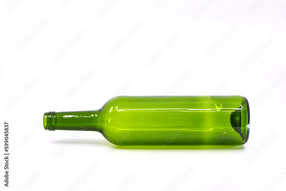 Empty green wine bottle lying on its side against a plain white background Empty green wine bottle lying on its side against a plain white background