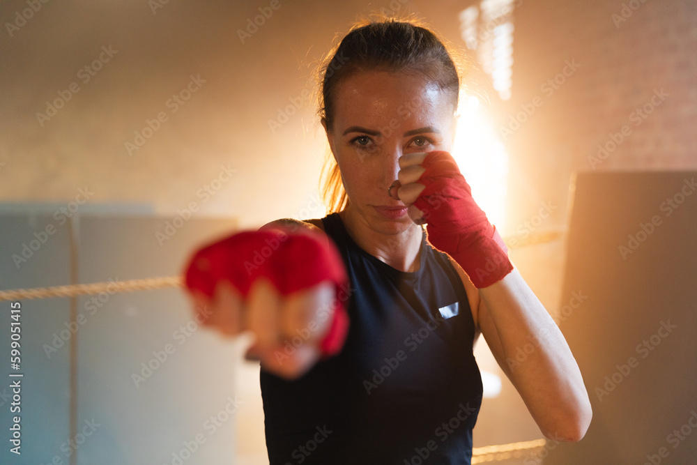 Women self defense girl power. Strong woman fighter punching with red