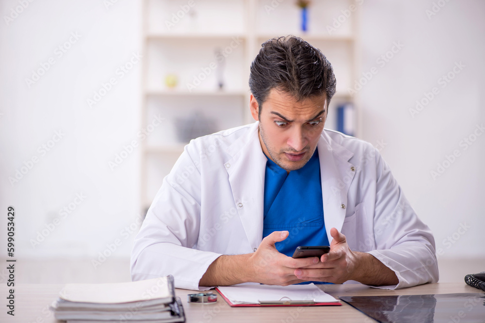 Young male doctor in telemedicine concept Young male doctor in telemedicine concept
