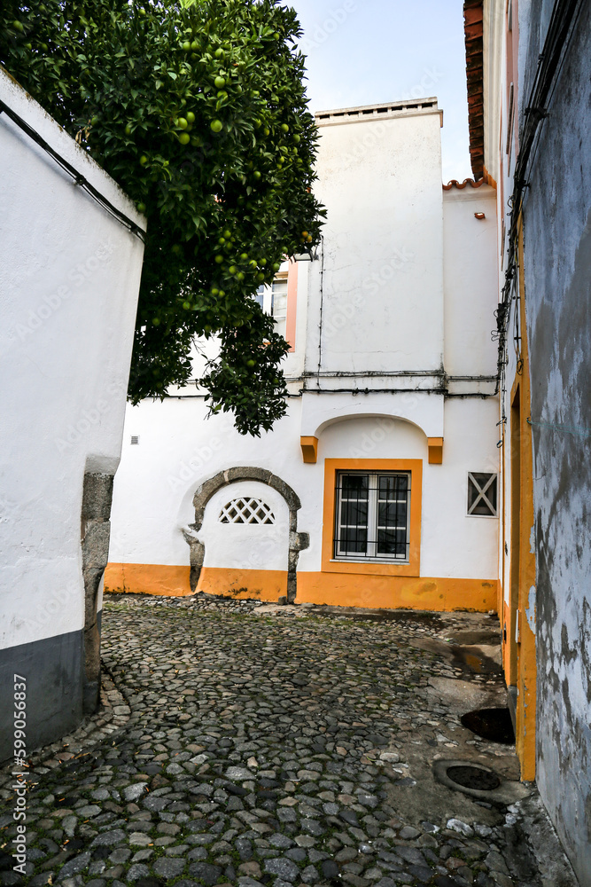 Typical Portuguese facades and narrow cobblestone streets in Evora