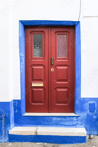 Typical Portuguese facade with colorful red door © SoniaBonet