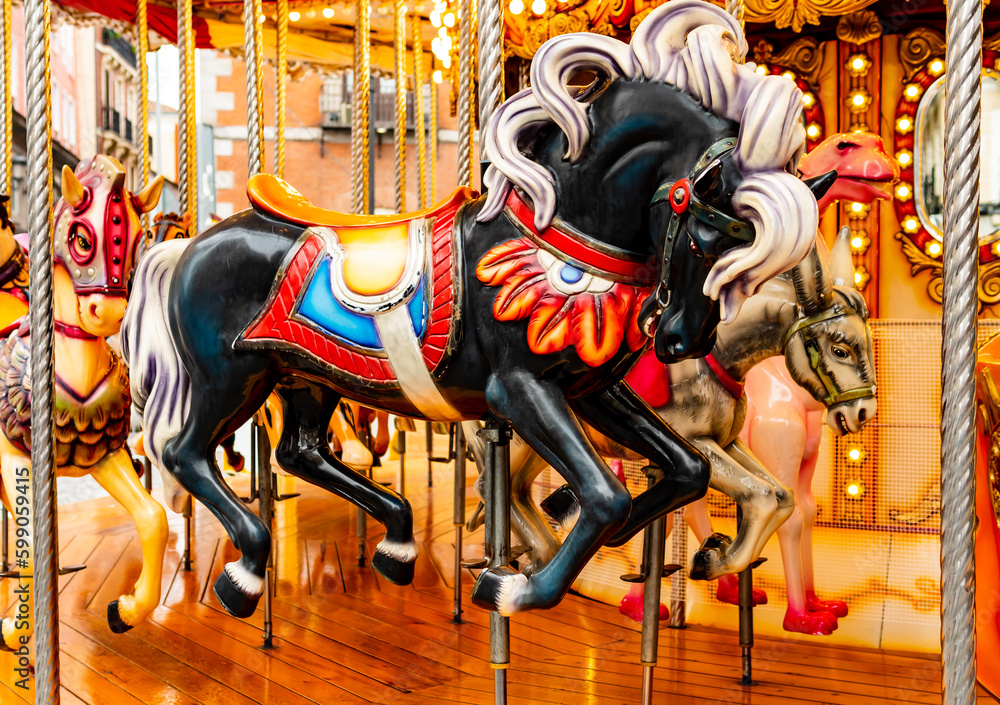 Beautiful black flying horse with traditional paintwork in a glittered vintage carousel  

