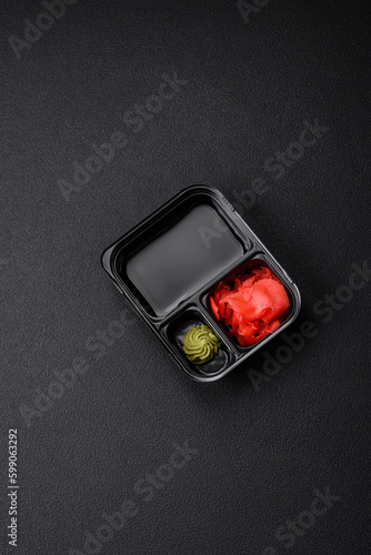 Pickled ginger, soy sauce and wasabi in portioned plastic containers