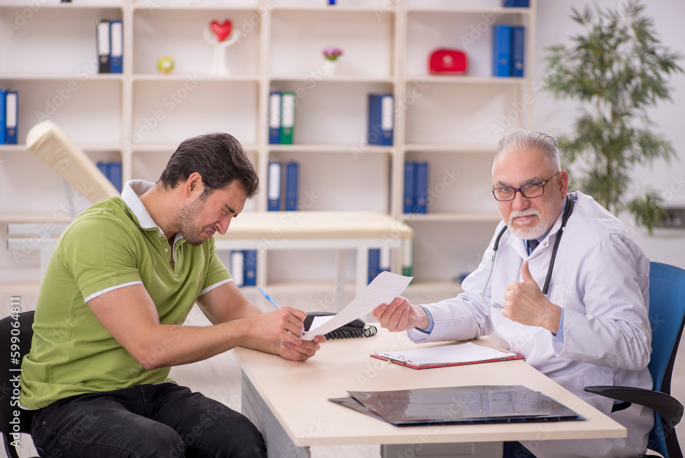 Young male patient visiting old male doctor