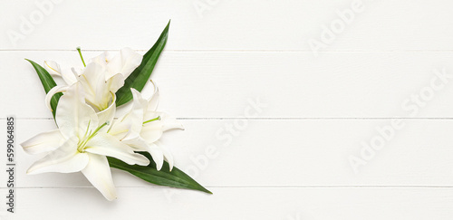 Fototapeta Naklejka Na Ścianę i Meble -  Delicate lily flowers on white wooden background with space for text