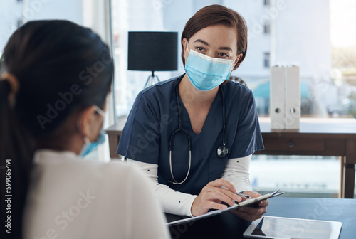 Are these details correct. a young female doctor writing down a patients information in an office.