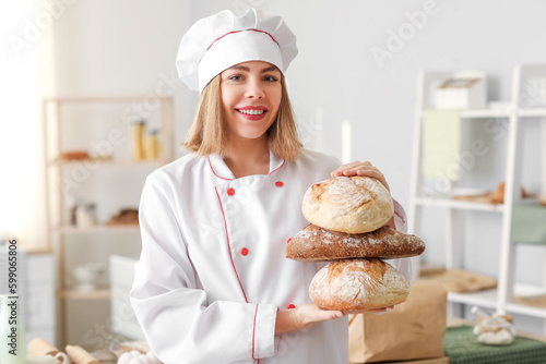 Female baker with loaves of...