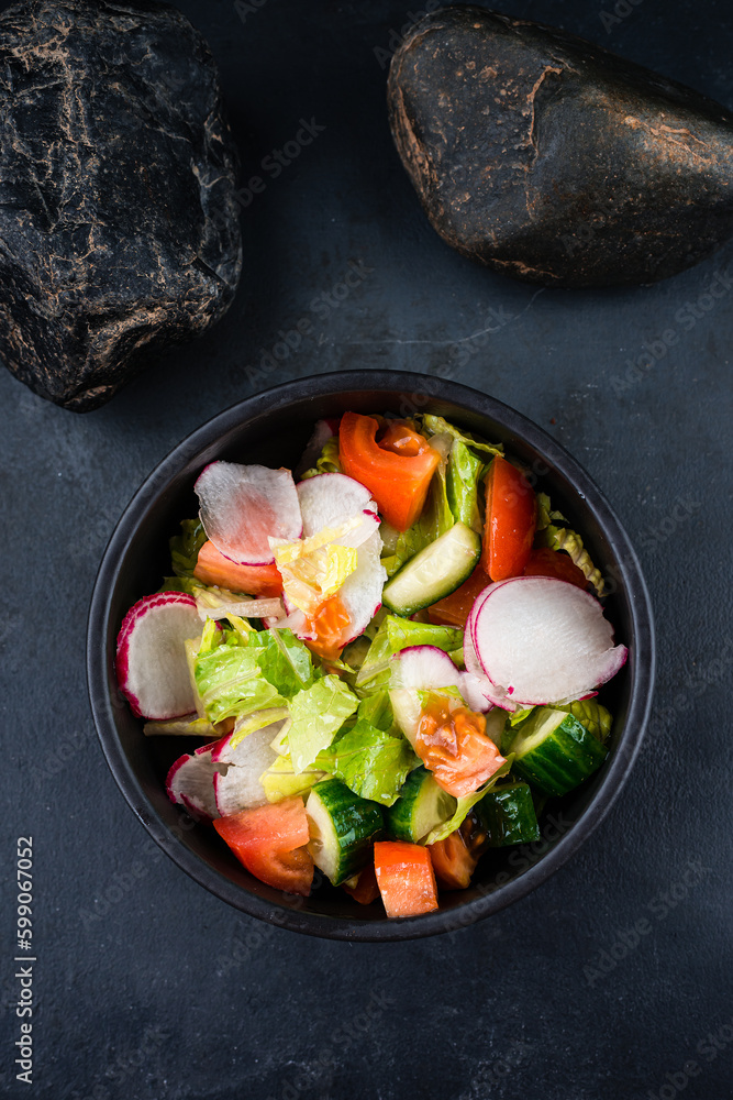 Green salad with cucumbers, lettuce, cherry tomatoes, and radish.