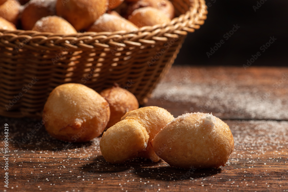 Raincake, basket with raincakes on rustic wood with black background, selective focus. Raincake, basket with raincakes on rustic wood with black background, selective focus.