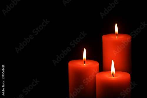 Three red candles black background