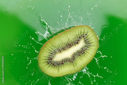 Kiwi slice in green juice with splashes