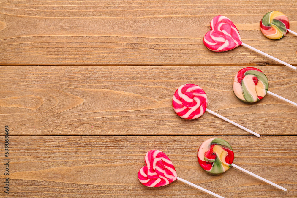 Composition with sweet lollipops on wooden table