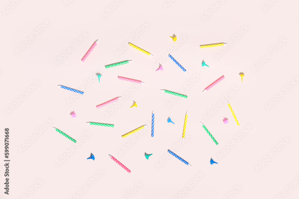 Colorful birthday candles on pink background Colorful birthday candles on pink background