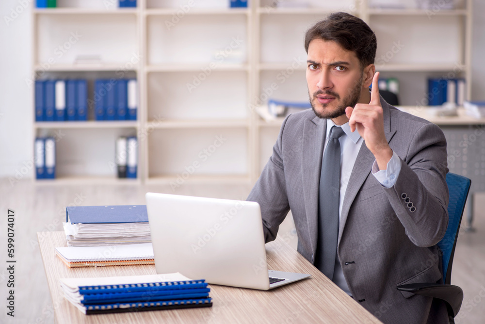 Young male employee working in the office Young male employee working in the office