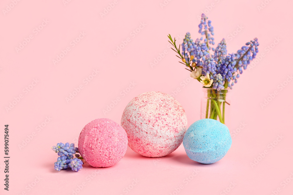 Bath bombs and vase with flowers on pink background Bath bombs and vase with flowers on pink background
