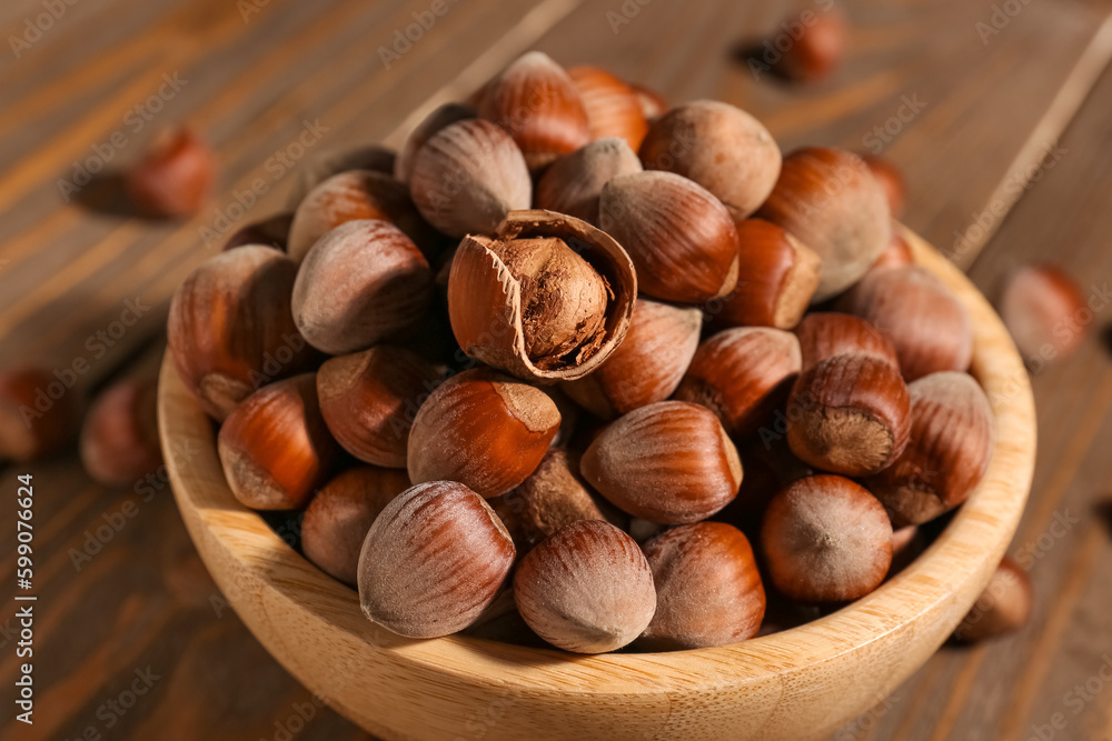 Bowl with shelled hazelnuts on wooden background Bowl with shelled hazelnuts on wooden background